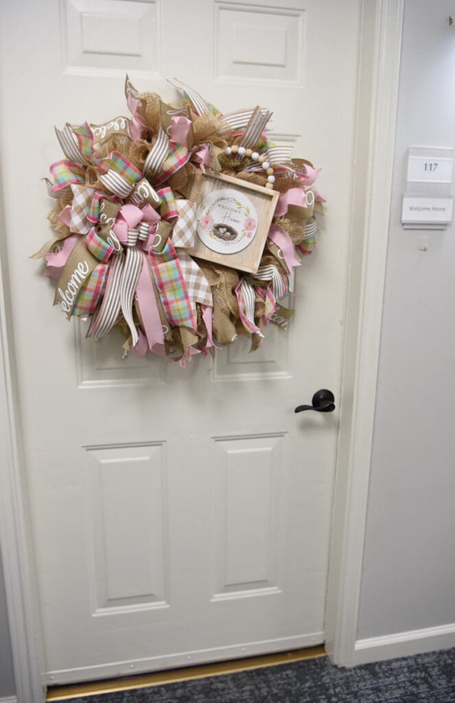 resident door decorated with springtime welcome wreath