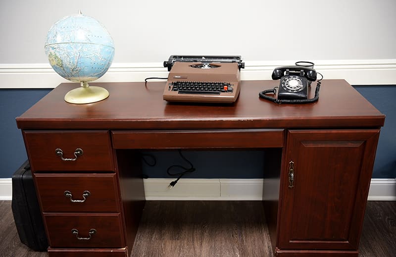 writing desk with typewriter, globe and phone