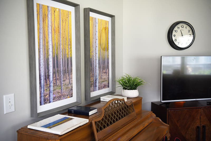 piano with artwork hanging above