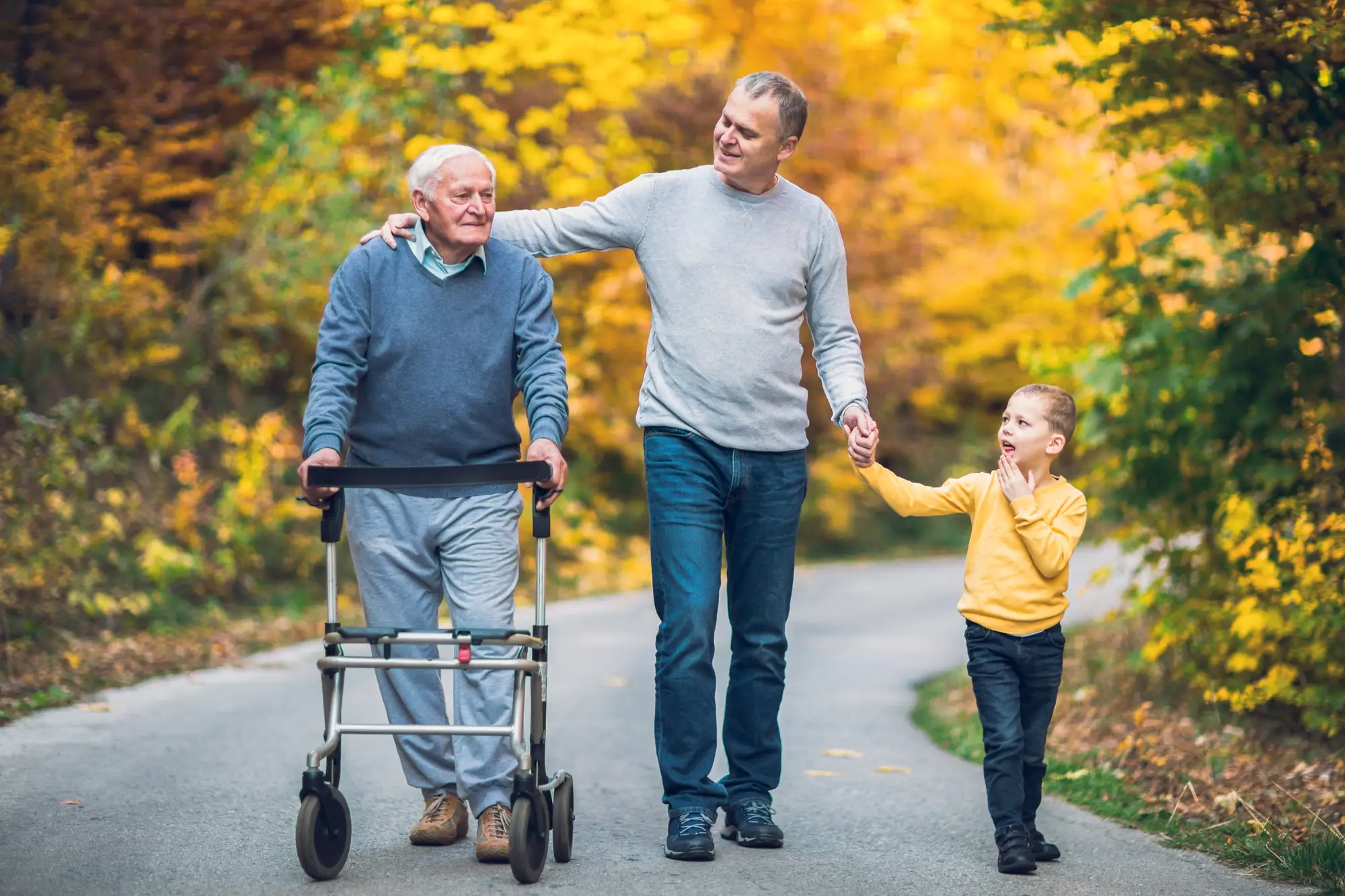 senior-man-with-walker-outside-with-family